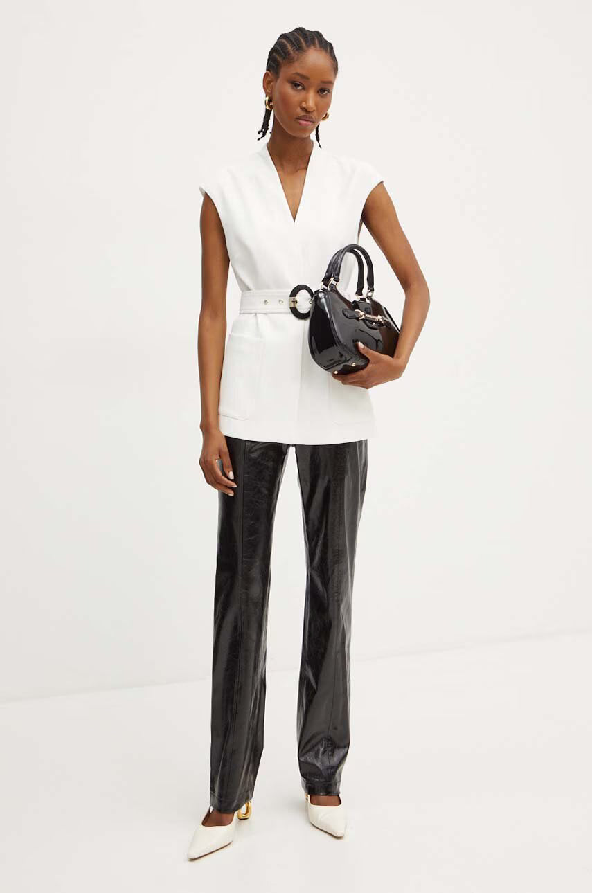 Marciano by Guess Lily Vest - White worn by a model with glossy black pants and accessories, showcasing women's fashion elegance.