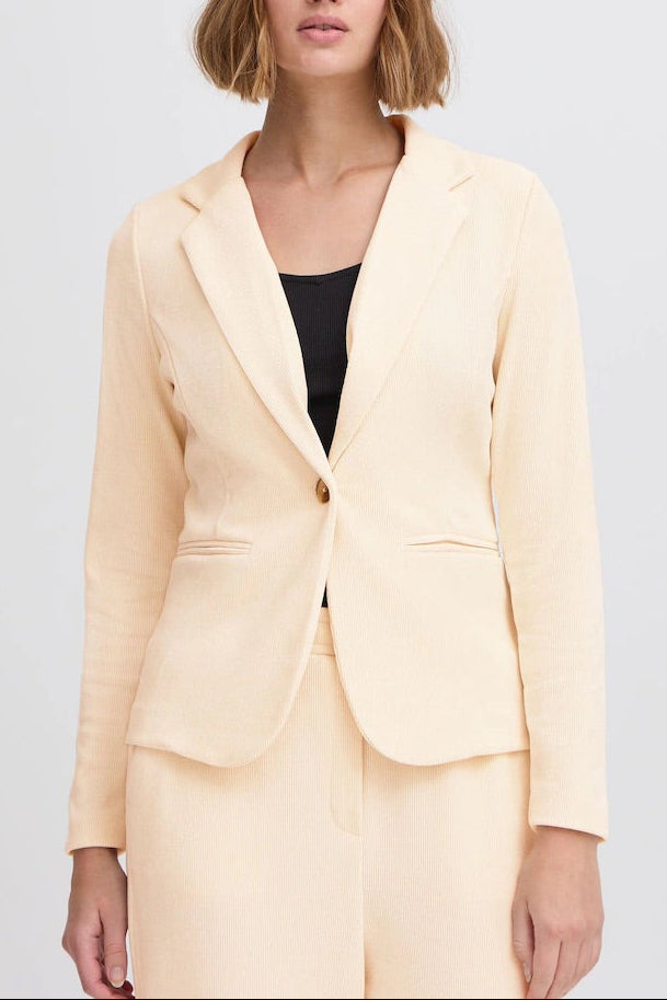 ICHI KATE ivory corduroy blazer buttoned on a model, showing the front fit, long sleeves and two welt pockets.