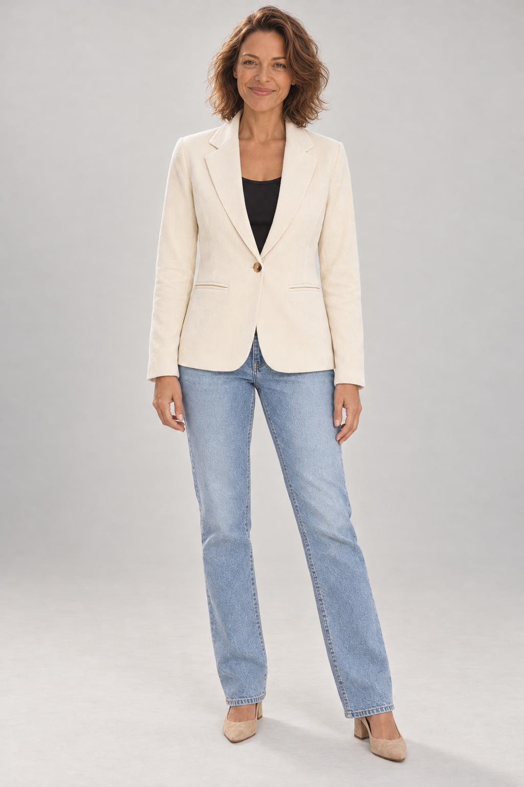 Emma wearing the ICHI KATE ivory corduroy blazer with a black top and light blue jeans against a neutral studio background.
