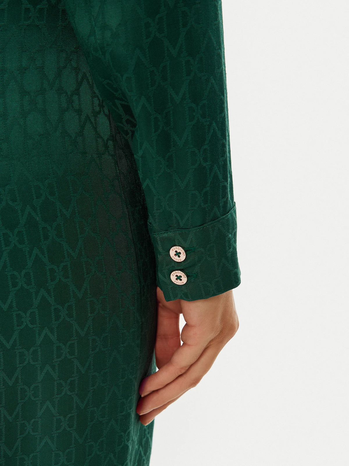 Close-up of the sleeve detail of the Marciano by Guess Amalia Dress - Green showcasing premium fabric and elegant design.