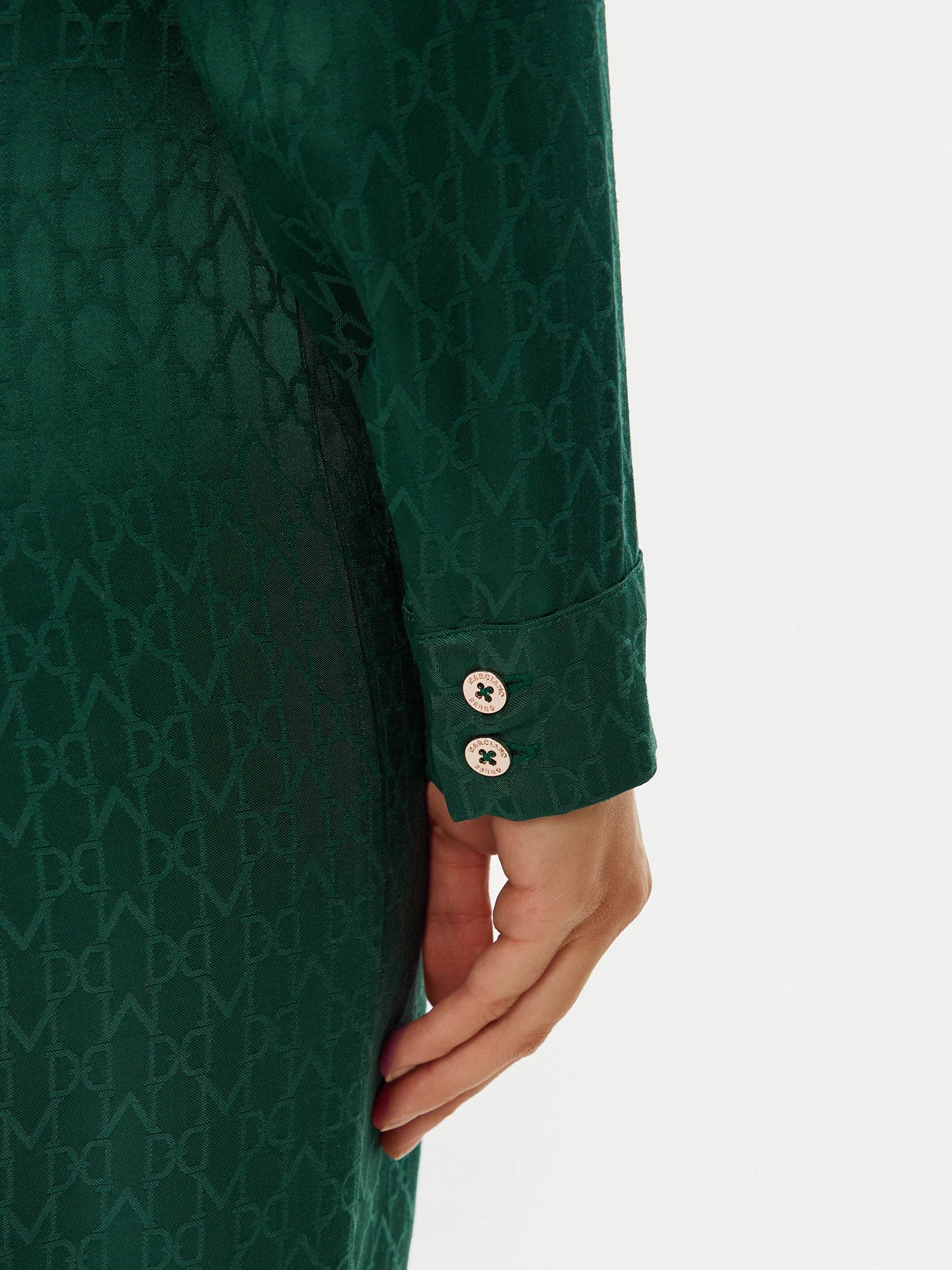 Close-up of the sleeve detail of the Marciano by Guess Amalia Dress - Green showcasing premium fabric and elegant design.